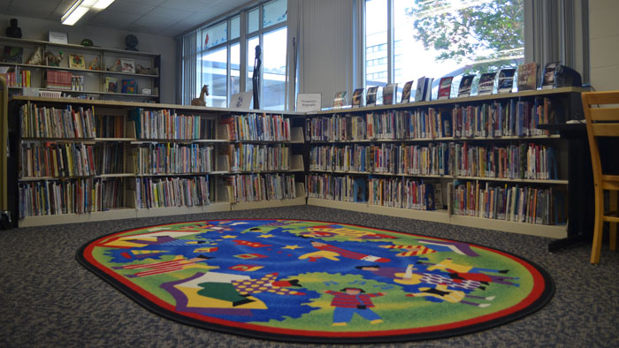 Children's books and story rug are available in the library
